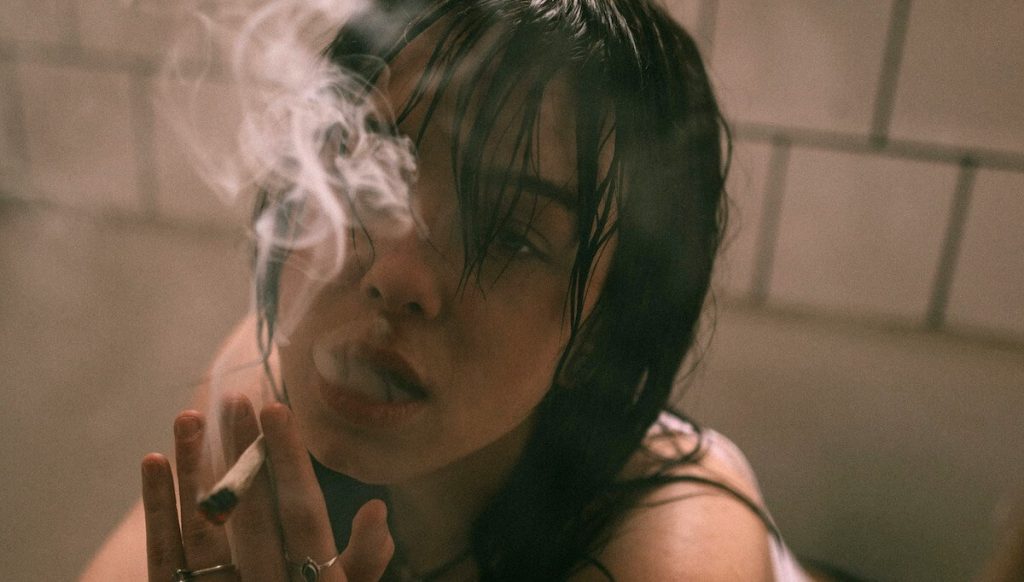 good looking woman smokes joint